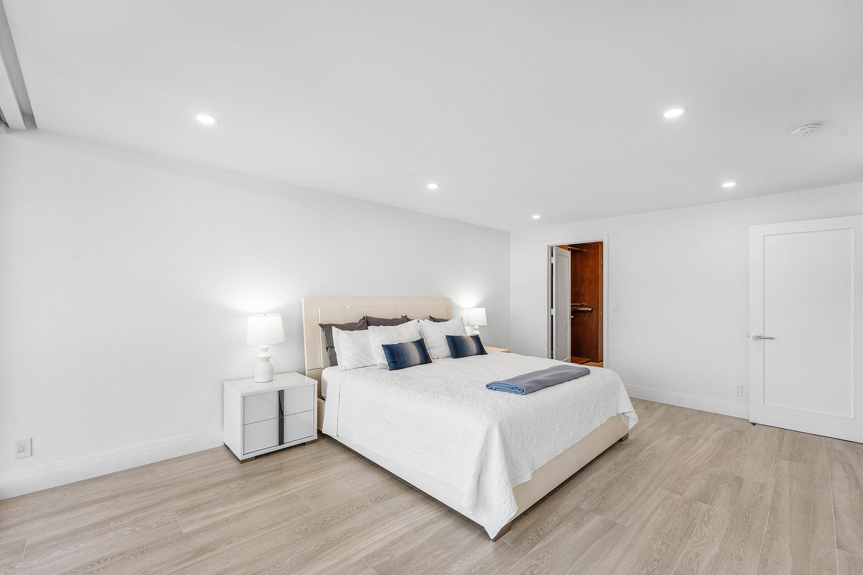 250 South Ocean Boulevard, Unit 4F Boca Raton, FL 33432 - Photo 28 of 45 a bedroom with a bed and a night stand