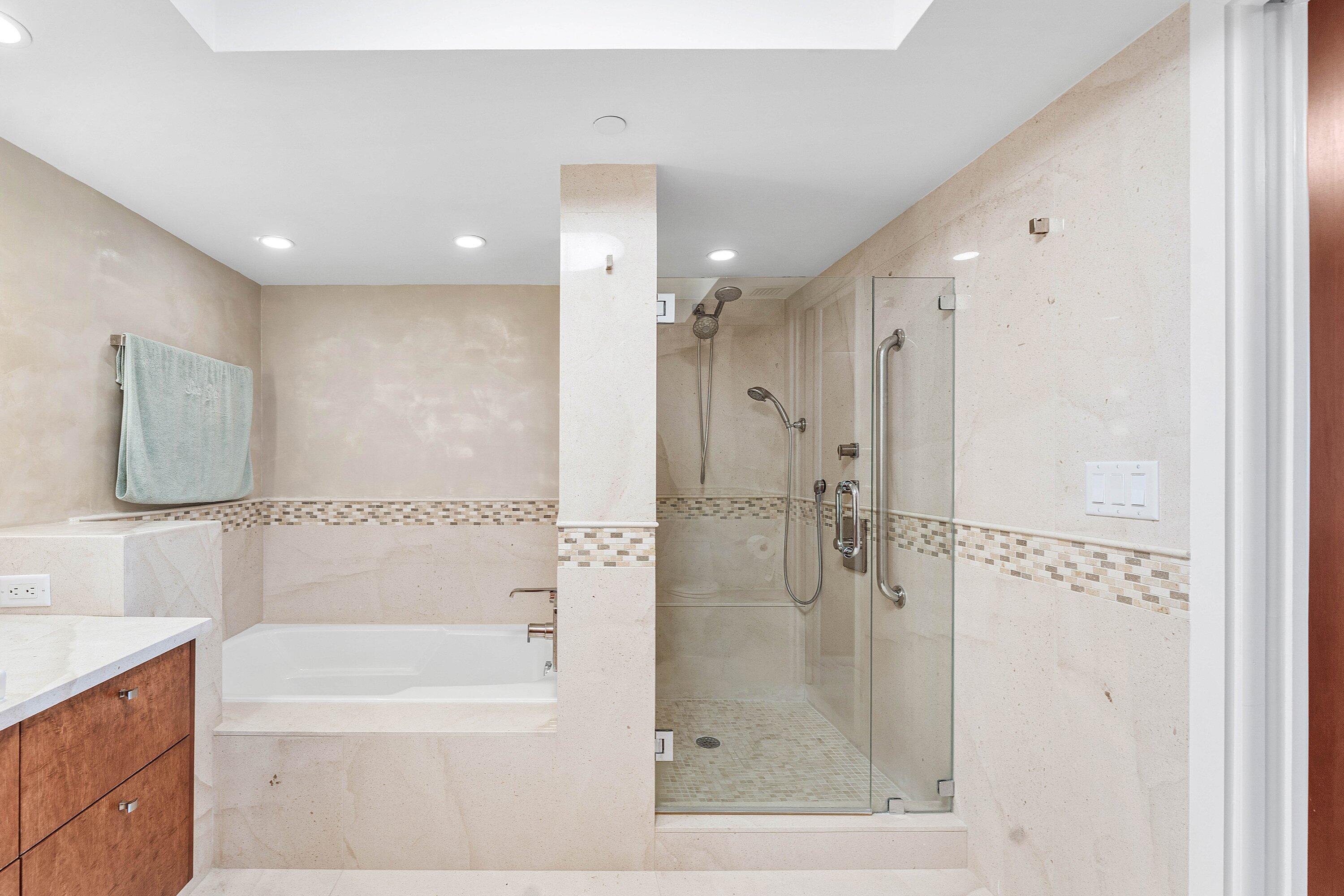 250 South Ocean Boulevard, Unit 4F Boca Raton, FL 33432 - Photo 33 of 45 a bathroom with a glass shower door