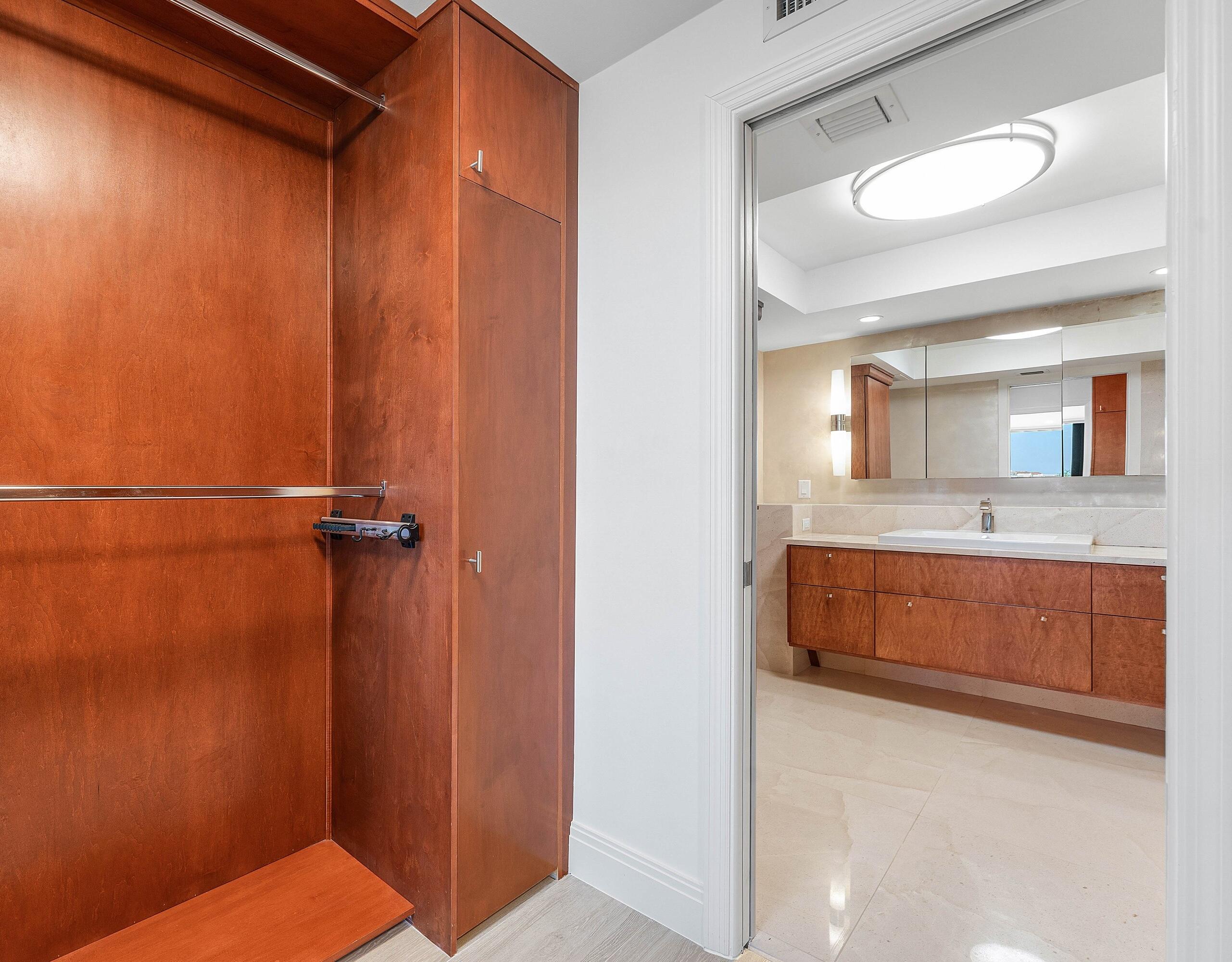 250 South Ocean Boulevard, Unit 4F Boca Raton, FL 33432 - Photo 36 of 45 a bathroom with a granite countertop sink a mirror and a bathtub