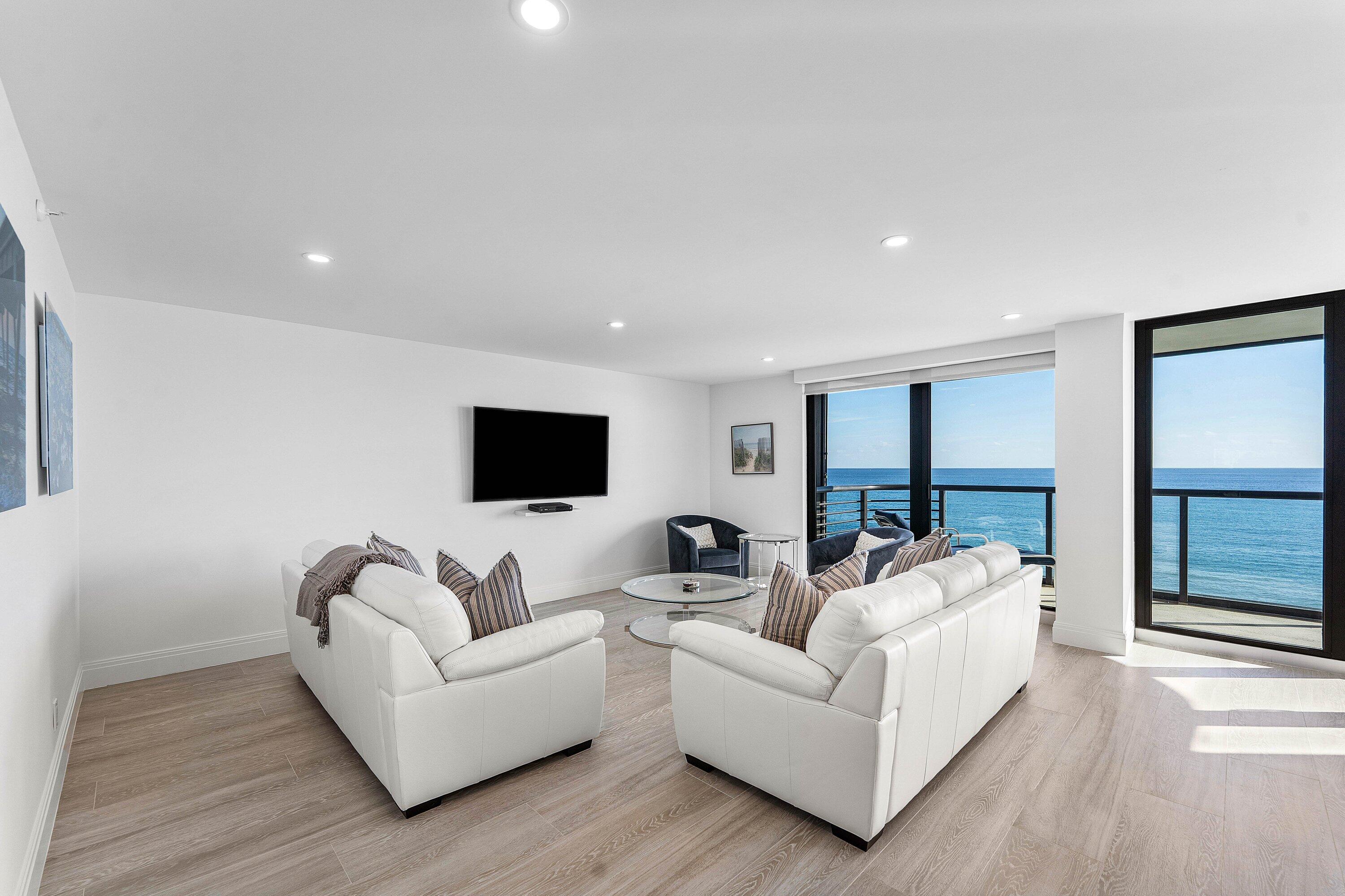 250 South Ocean Boulevard, Unit 4F Boca Raton, FL 33432 - Photo 5 of 45 a living room with furniture and a flat screen tv
