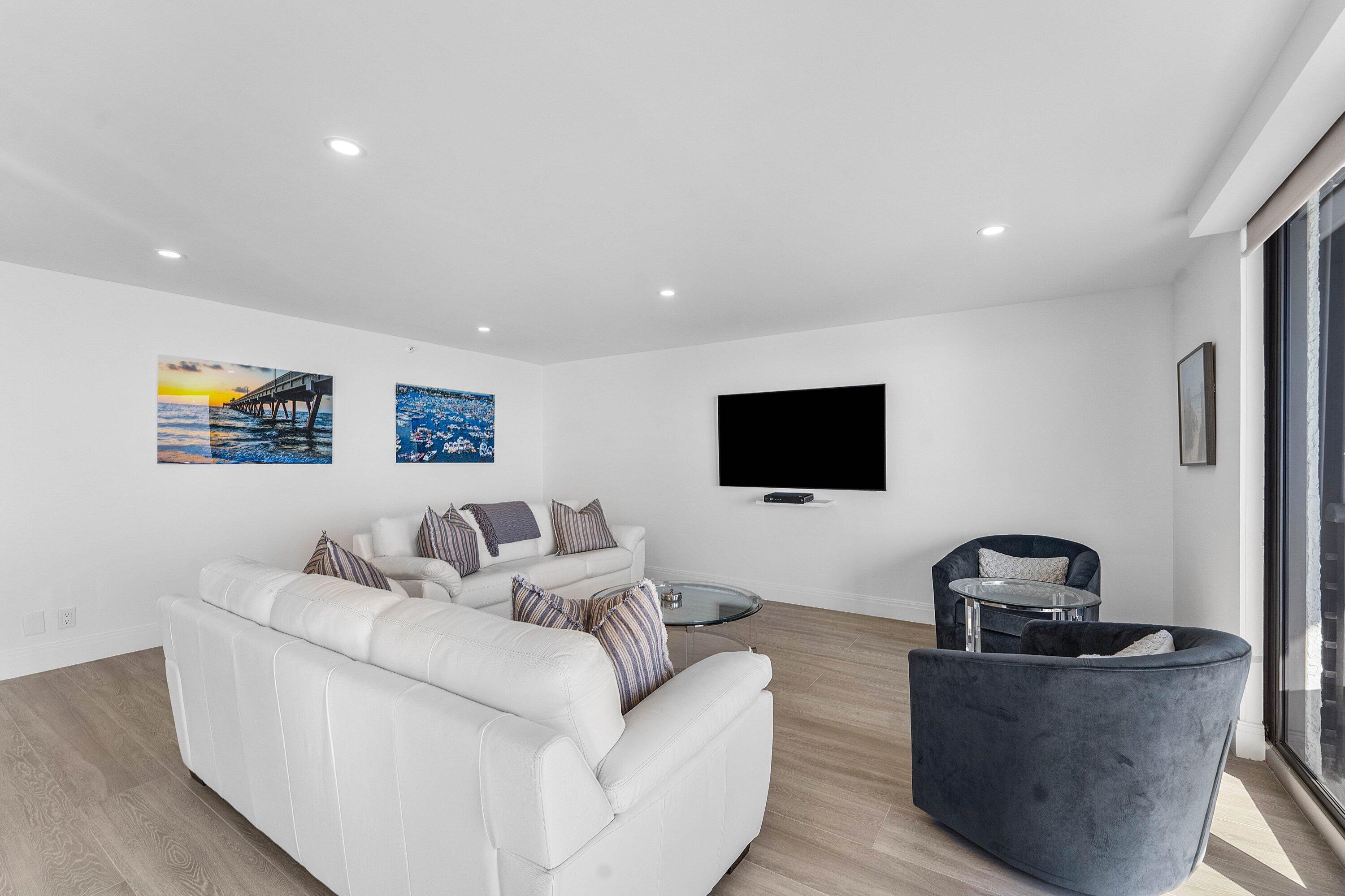 250 South Ocean Boulevard, Unit 4F Boca Raton, FL 33432 - Photo 6 of 45 a living room with furniture and a flat screen tv