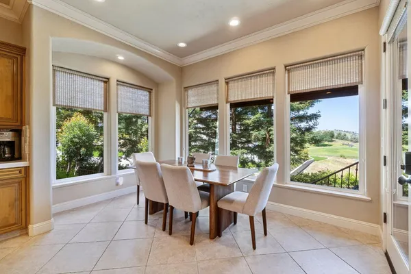 a spacious bedroom with a bed a chandelier and walk in closet