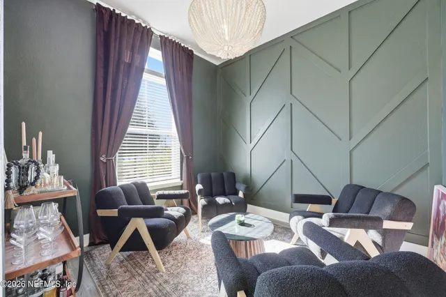 a kitchen with stainless steel appliances kitchen island wooden floor and refrigerator