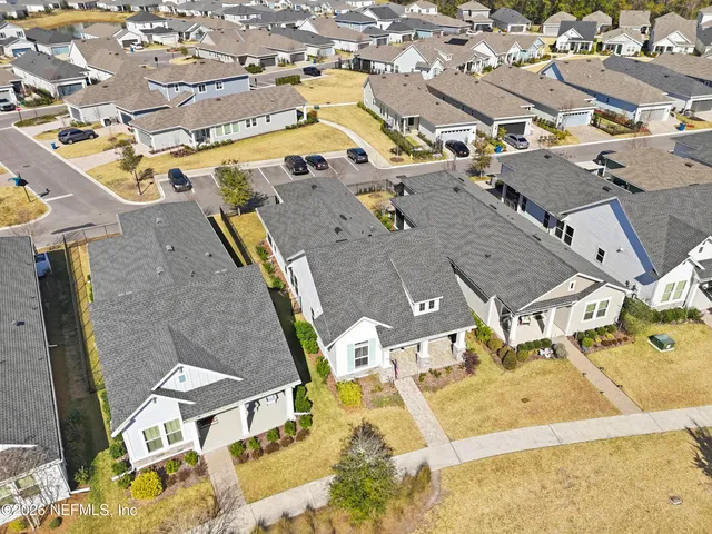 an aerial view of a house with a yard