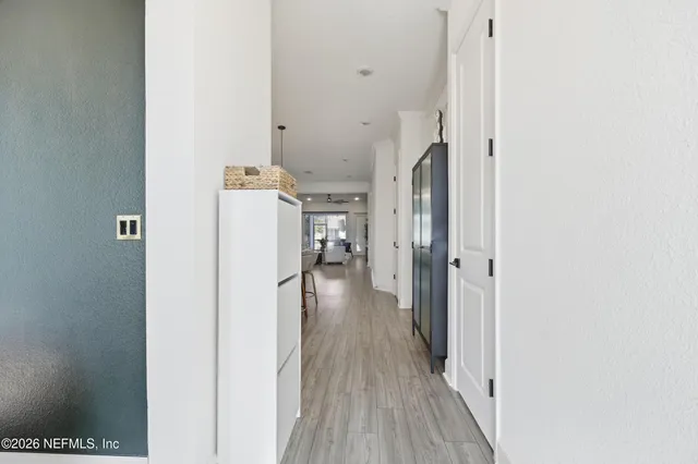 a kitchen with a dining table chairs sink and cabinets