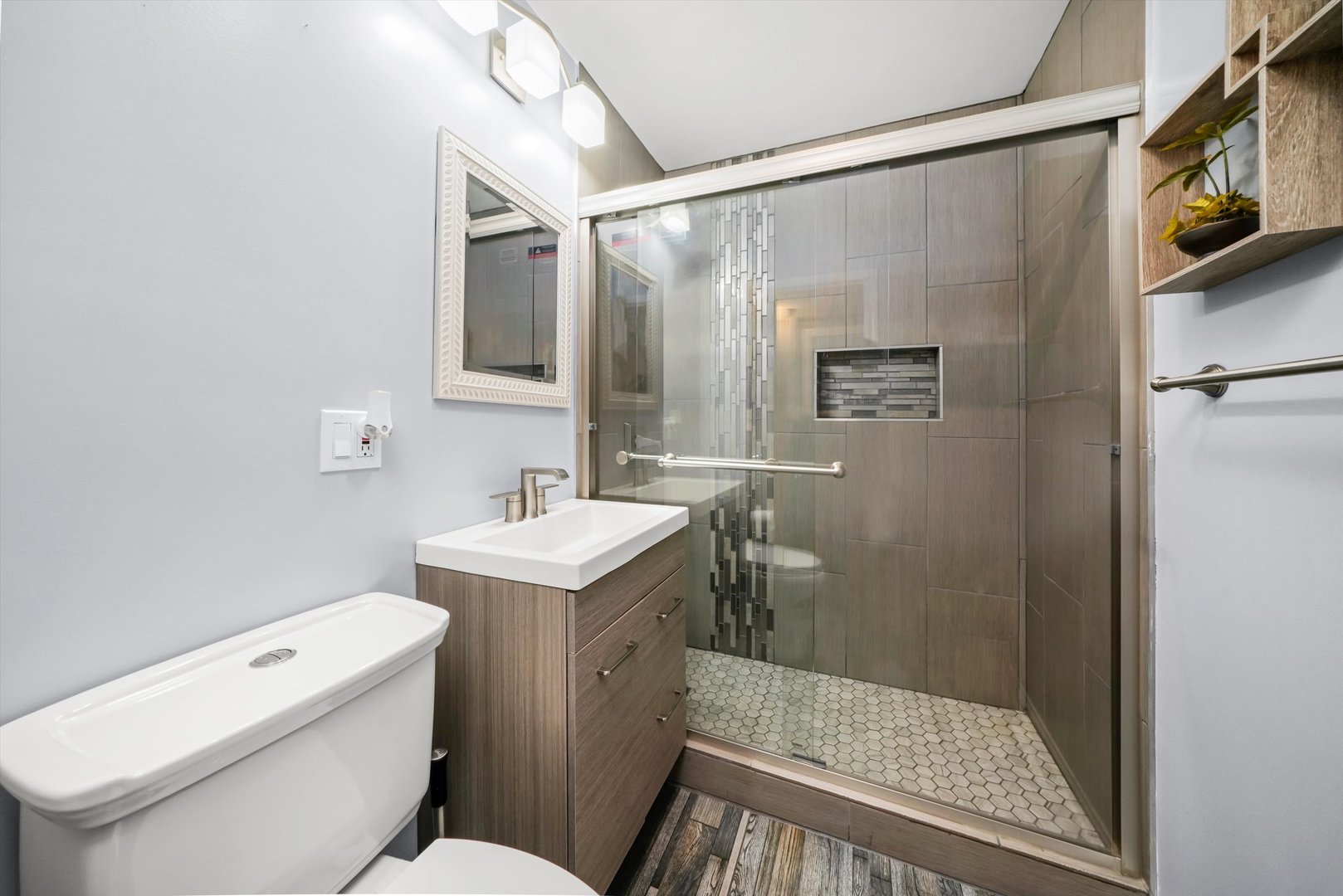 1106 Arthur Avenue Berkeley, IL 60163 - Photo 13 of 28 a bathroom with a sink a toilet a mirror and shower