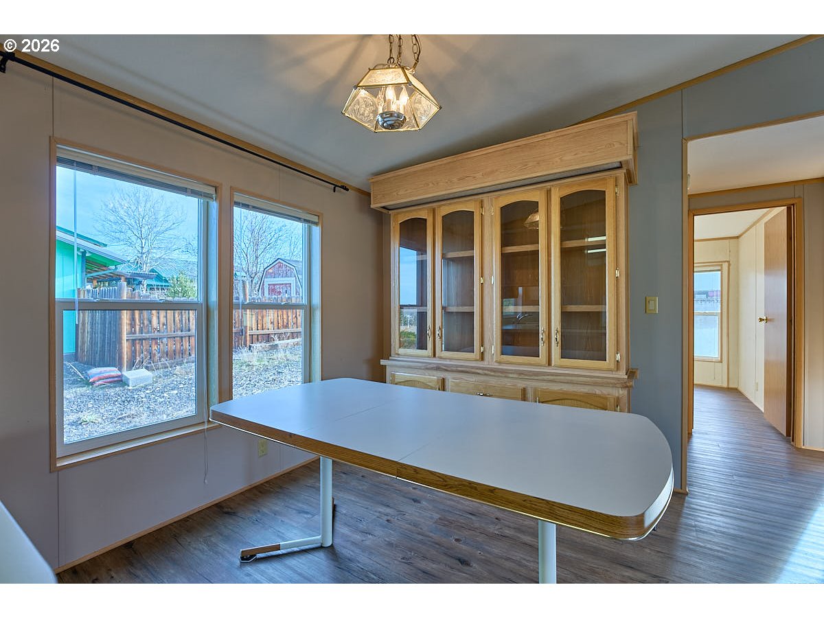 801 Residence Street Enterprise, OR 97828 - Photo 12 of 20 a view of an empty room with wooden floor and a window