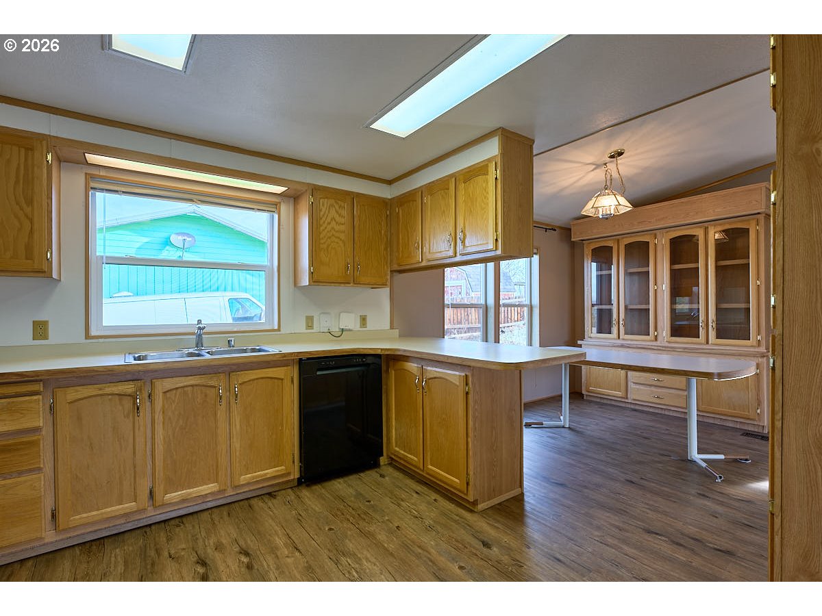 801 Residence Street Enterprise, OR 97828 - Photo 8 of 20 a kitchen with wooden floors and wooden cabinets