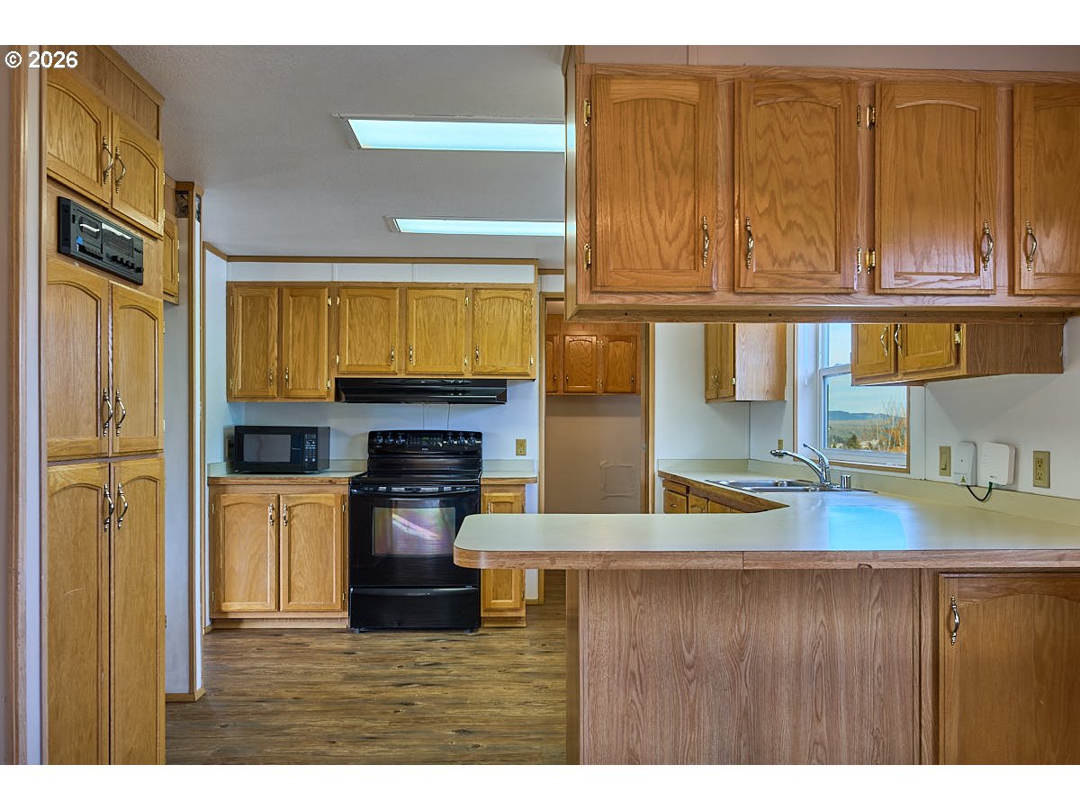 801 Residence Street Enterprise, OR 97828 - Photo 9 of 20 a kitchen with a refrigerator and a sink