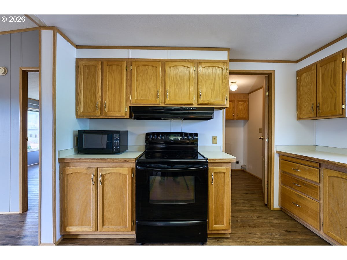 801 Residence Street Enterprise, OR 97828 - Photo 10 of 20 a kitchen with stainless steel appliances granite countertop a stove and a refrigerator