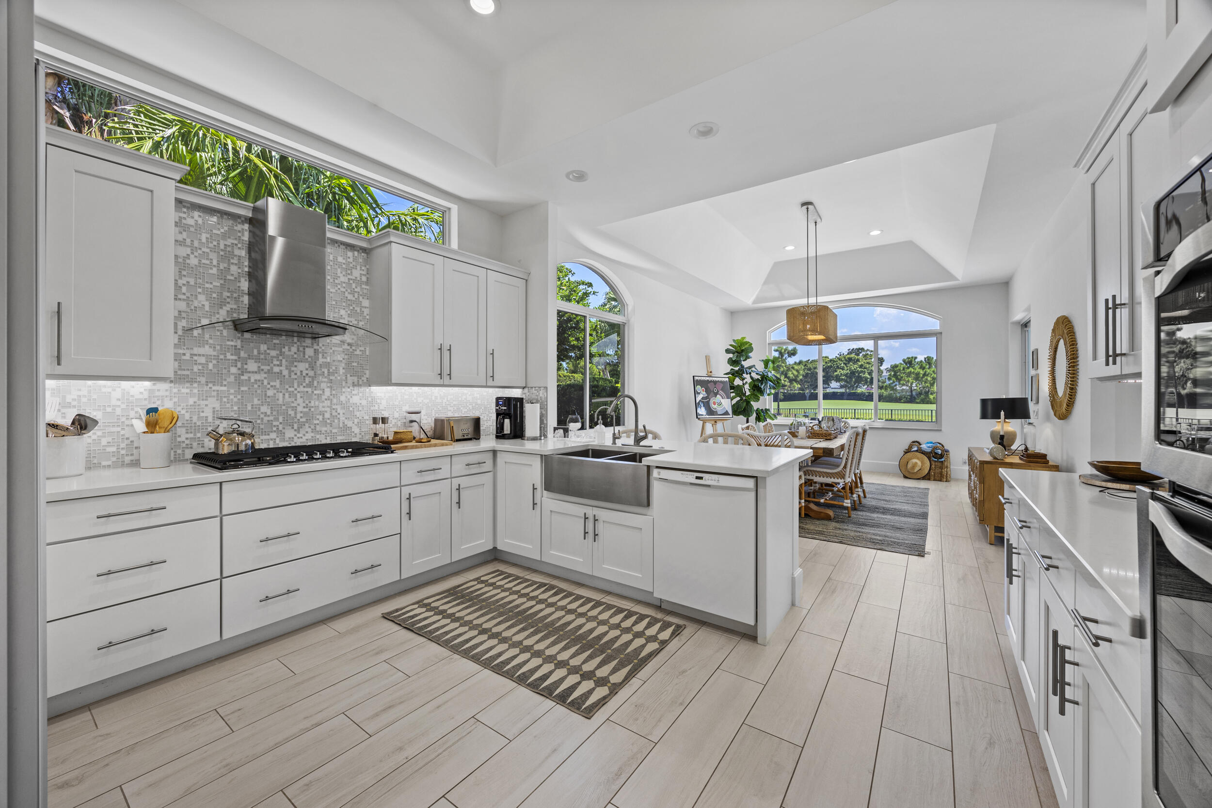 118 North Village Way Jupiter, FL 33458 - Photo 8 of 28 a kitchen with sink cabinets and window