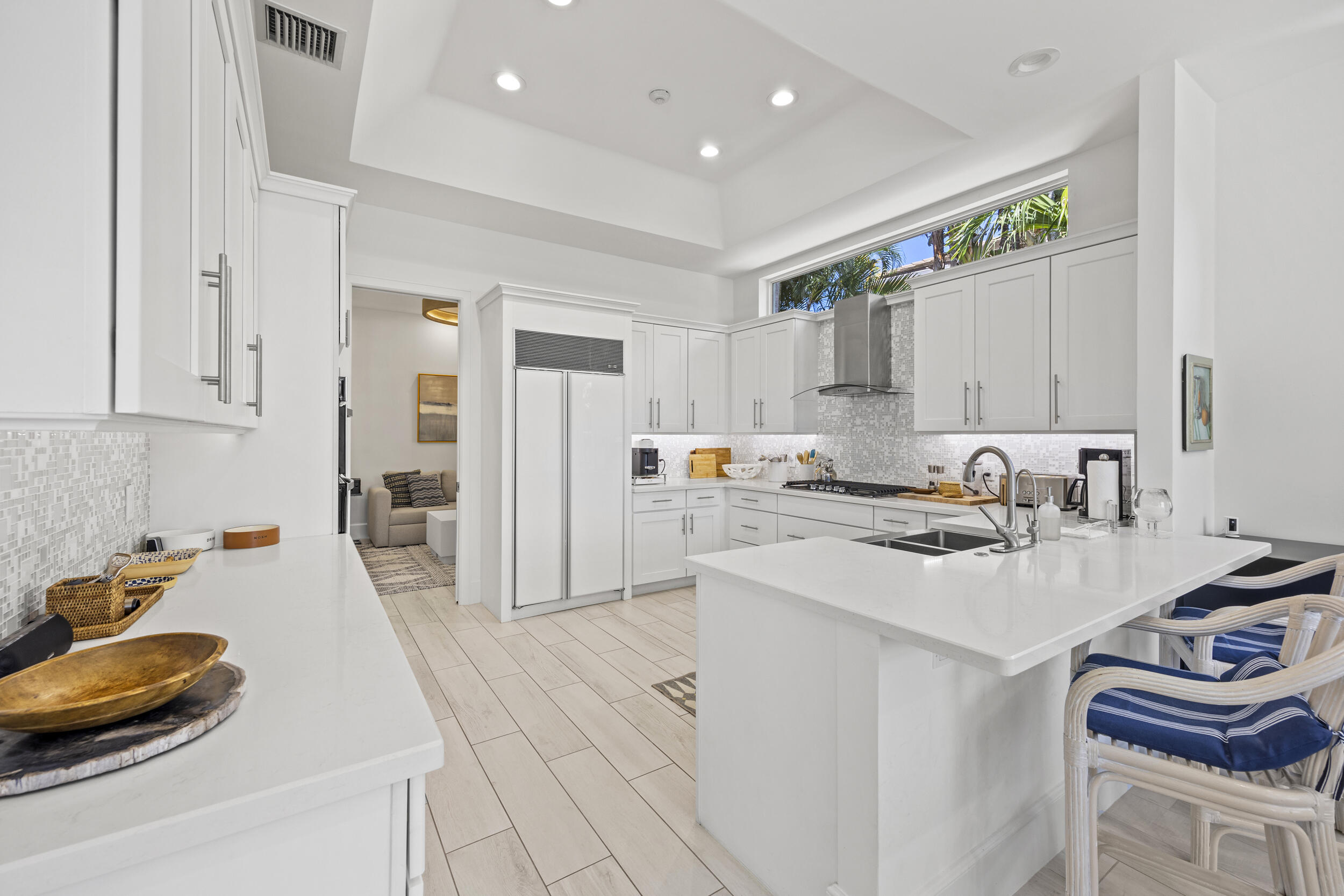 118 North Village Way Jupiter, FL 33458 - Photo 9 of 28 a kitchen with white cabinets and appliances