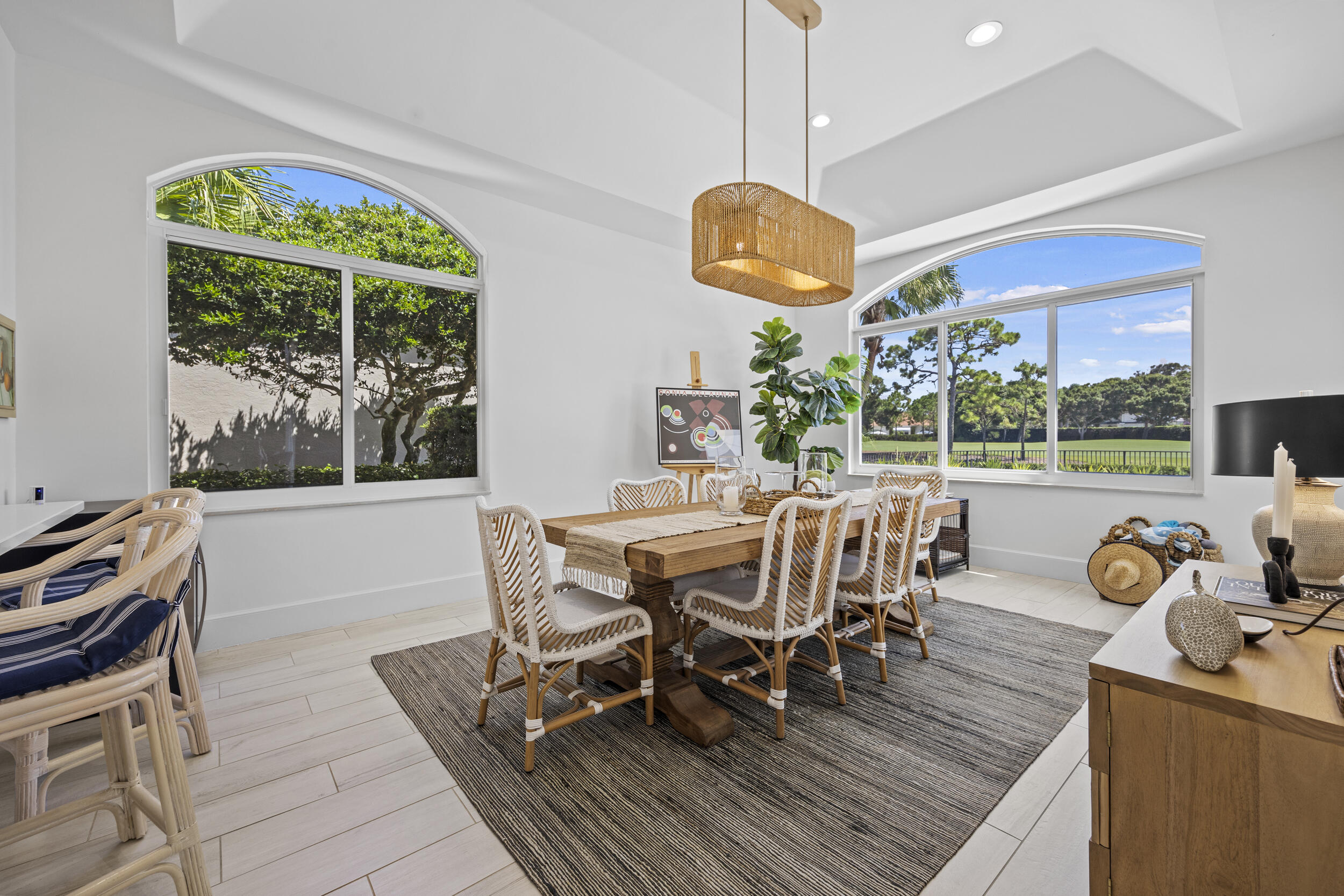 118 North Village Way Jupiter, FL 33458 - Photo 10 of 28 a view of a dining room with furniture a chandelier and wooden floor