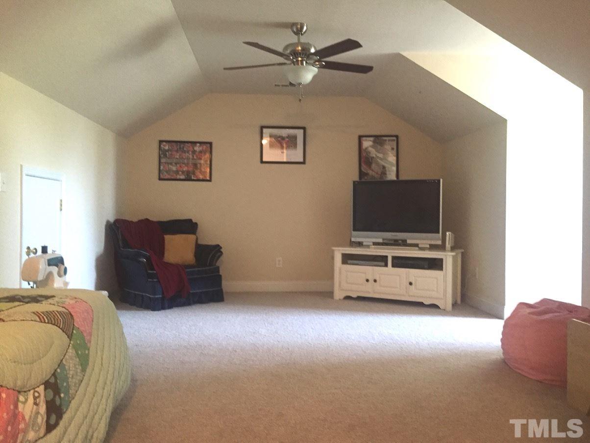 9525 Vira Drive Raleigh, NC 27617 - Photo 12 of 13 a bedroom with furniture and a flat screen tv