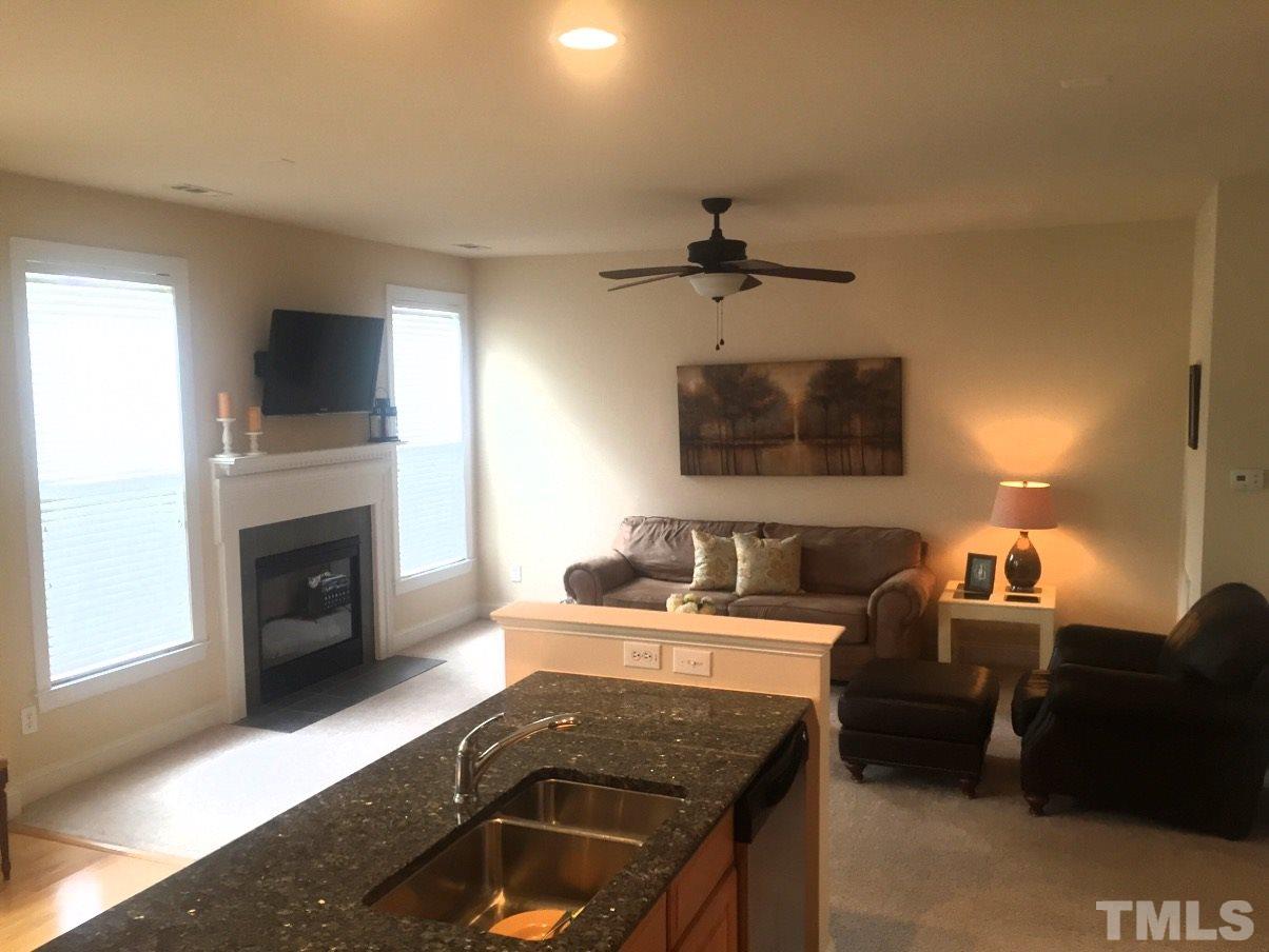 9525 Vira Drive Raleigh, NC 27617 - Photo 6 of 13 a kitchen with a sink and a fireplace