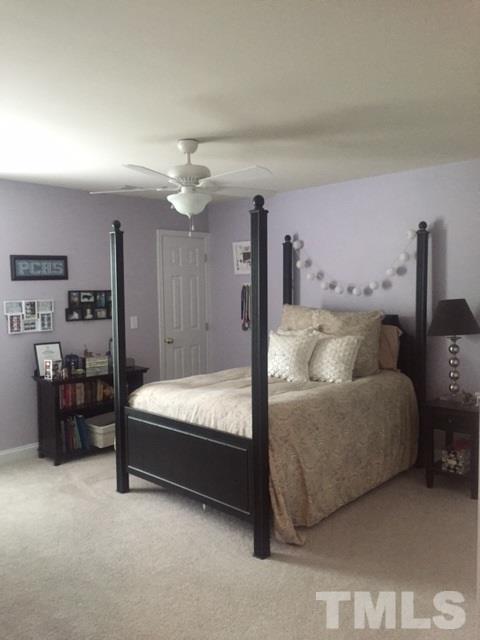 9525 Vira Drive Raleigh, NC 27617 - Photo 9 of 13 a bed room with furniture and a chandelier
