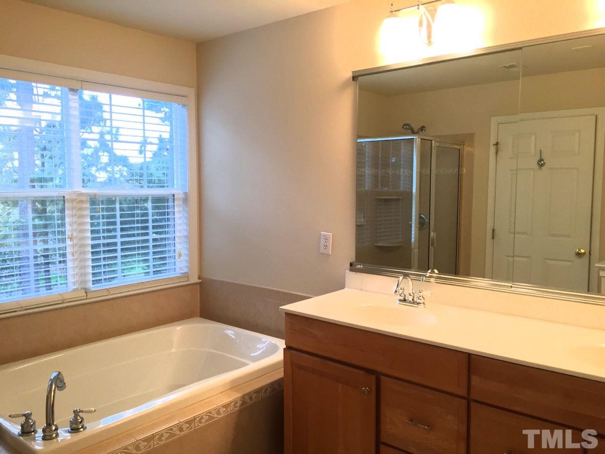 9525 Vira Drive Raleigh, NC 27617 - Photo 10 of 13 a bathroom with a bathtub and a sink