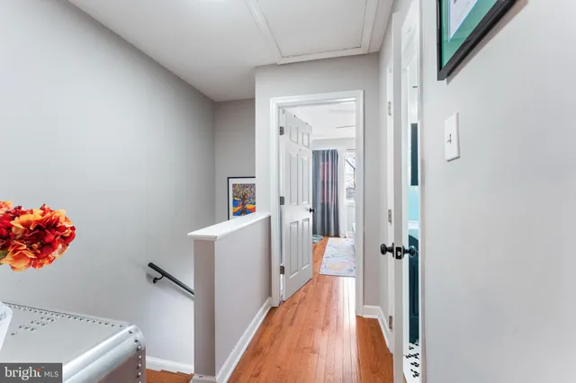 a view of a hallway to a livingroom with furniture
