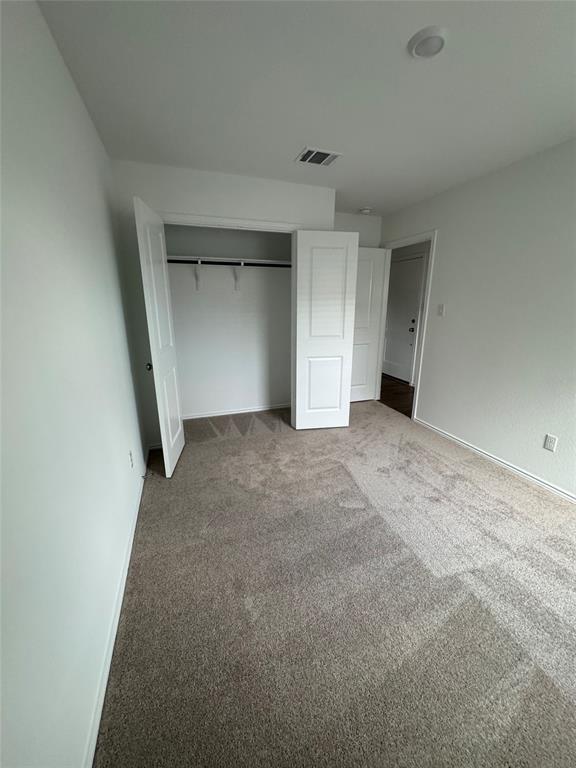 216 Jeffers Kyle, TX 78640 - Photo 11 of 19 Neutral-toned carpeting extends throughout this room, featuring white walls and baseboards