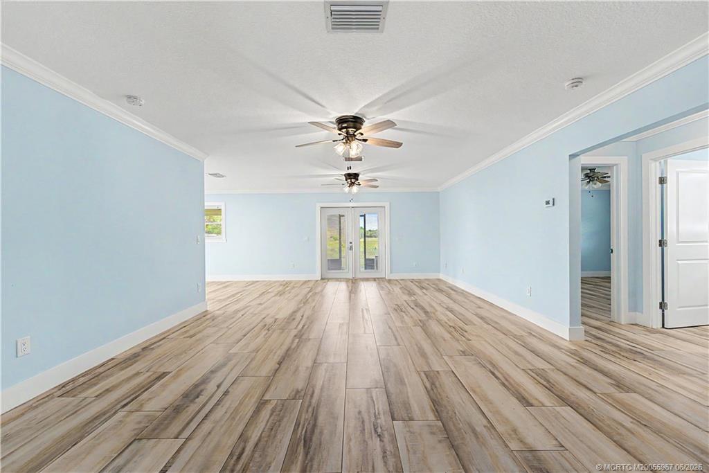 8200 Southwest Springhaven Avenue Indiantown, FL 34956 - Photo 20 of 35 wooden floor in an empty room with a window