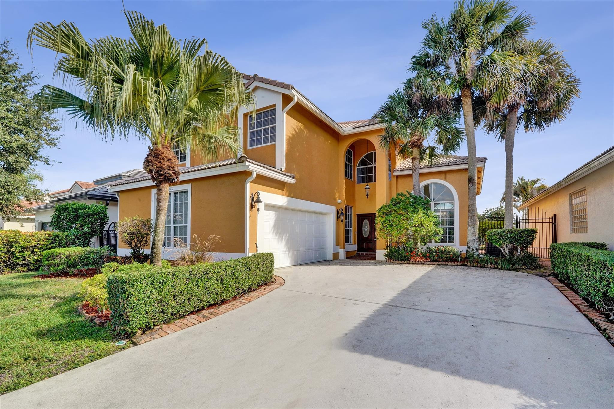 10902 Tamoron Lane Boca Raton, FL 33498 - Photo 2 of 66 a front view of a house with a garden