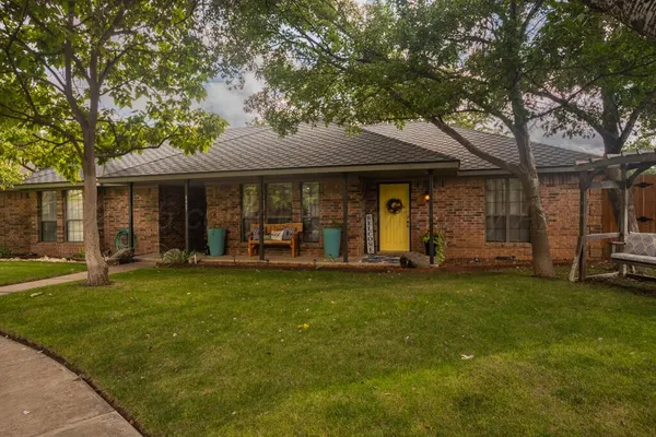 a view of a house with backyard porch and furniture