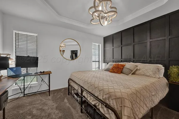 a bedroom with a bed and a chandelier