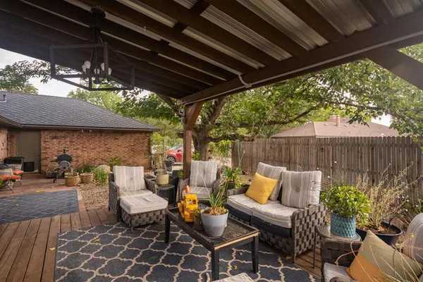 a patio with patio couch and chairs