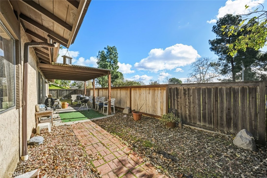 2202 Village Road Escondido, CA 92026 - Photo 12 of 15 a view of a backyard with table and chairs and a large tree