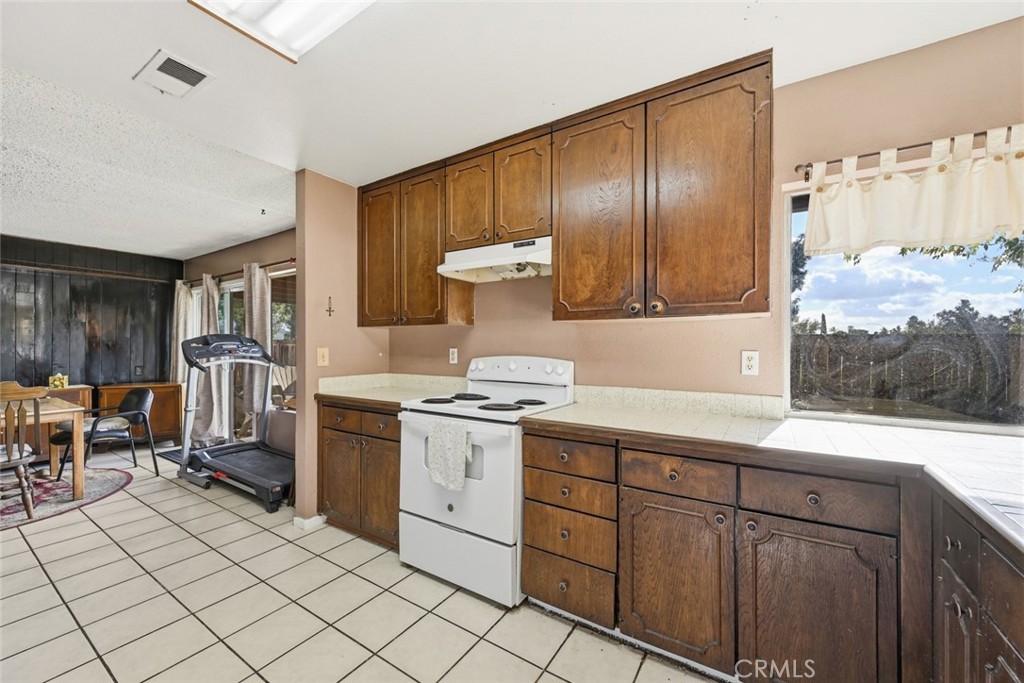 2202 Village Road Escondido, CA 92026 - Photo 4 of 15 a kitchen with granite countertop cabinets and window