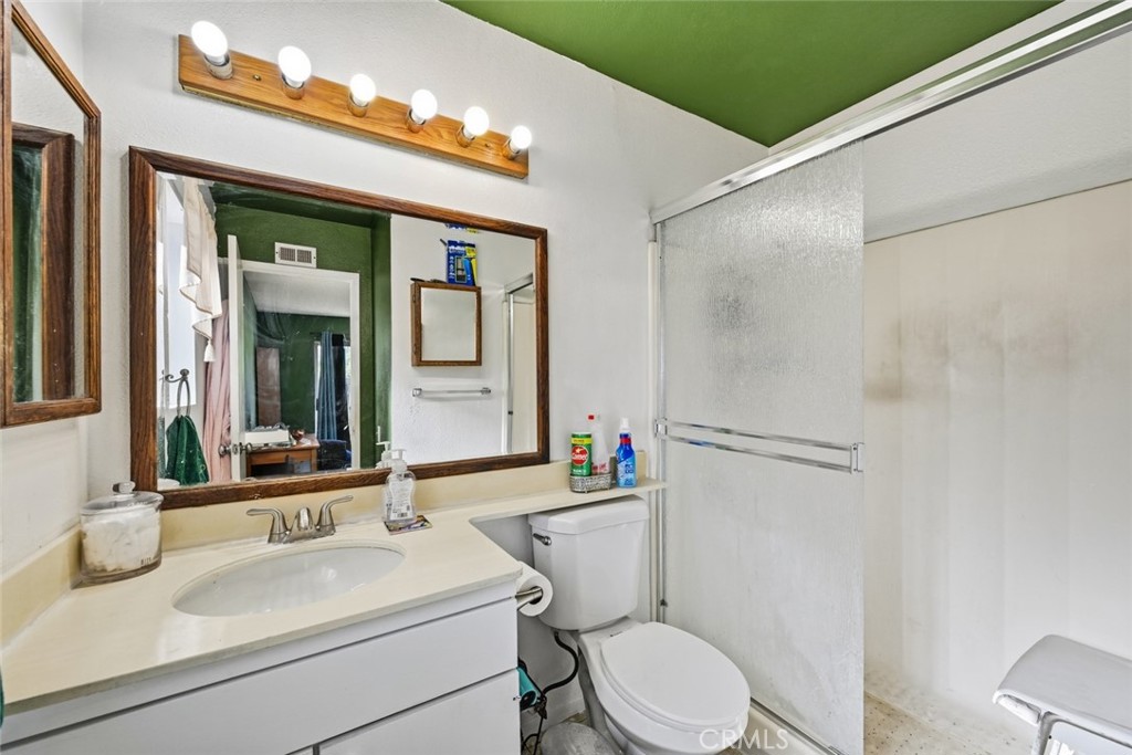 2202 Village Road Escondido, CA 92026 - Photo 10 of 15 a bathroom with a sink vanity mirror and toilet