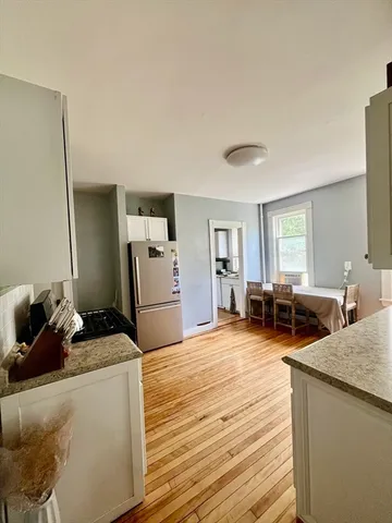 a bathroom with a sink a toilet and shower curtain