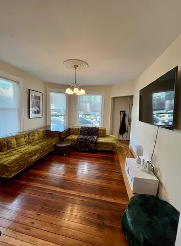 a kitchen with a sink white cabinets and white appliances