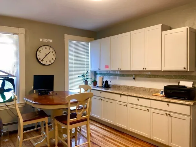 a kitchen with stainless steel appliances kitchen island granite countertop a sink stove and cabinets