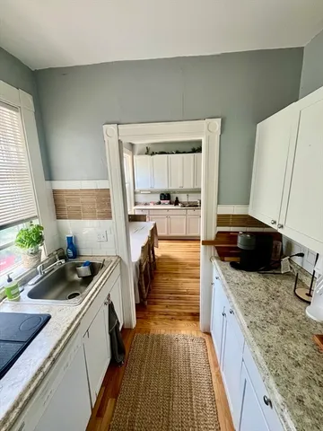a kitchen with a refrigerator and a stove top oven
