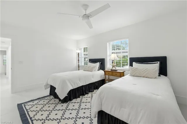 a bedroom with two beds and a dresser