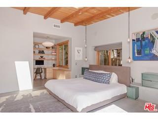 433 Sycamore Road Santa Monica, CA 90402 - Photo 17 of 28 a bedroom with a large bed and a chandelier