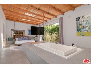 433 Sycamore Road Santa Monica, CA 90402 - Photo 20 of 28 a bedroom with a bed and a flat screen tv