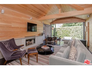 433 Sycamore Road Santa Monica, CA 90402 - Photo 6 of 28 a living room with furniture a flat screen tv and a large window