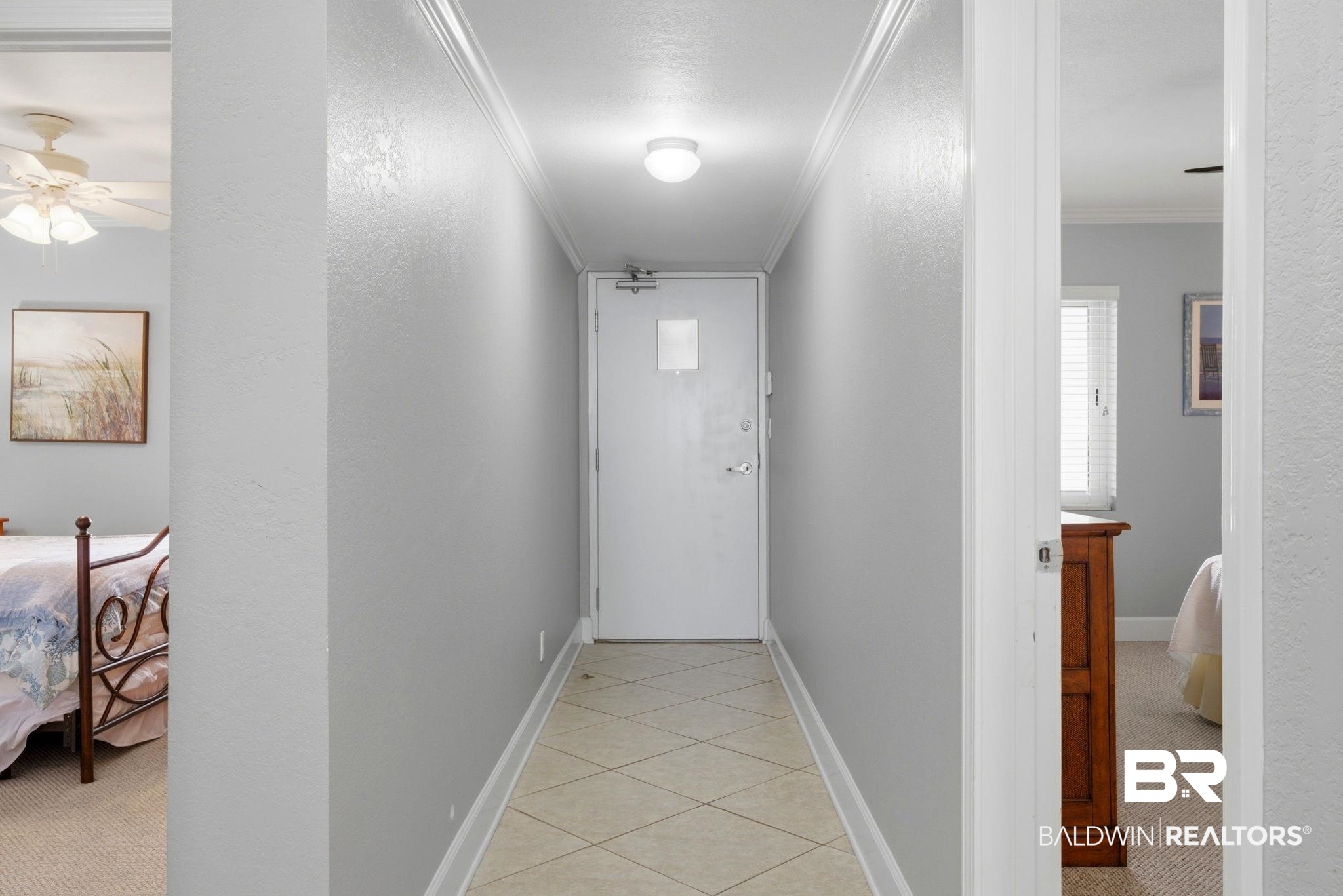 16284 Perdido Key Drive, Unit 912 Perdido Key, FL 32507 - Photo 10 of 49 Hallway featuring ornamental molding, a textured wall, light carpet, and light tile patterned flooring