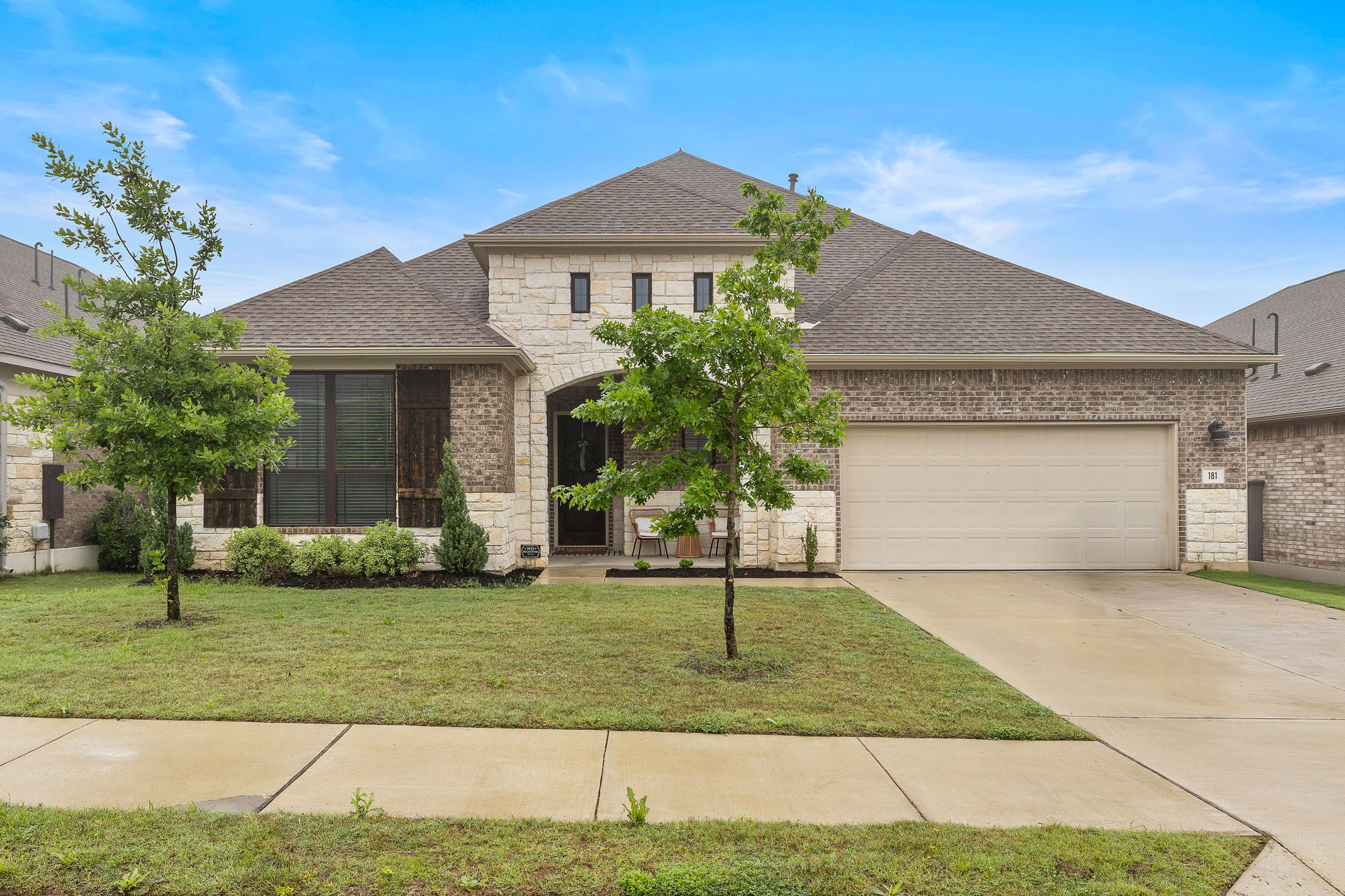 181 Constitution Way Kyle, TX 78640 - Photo 1 of 32 a front view of a house with a yard
