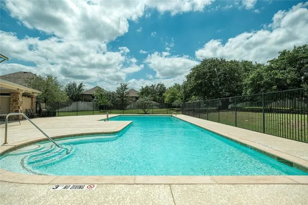 a view of a swimming pool with a yard