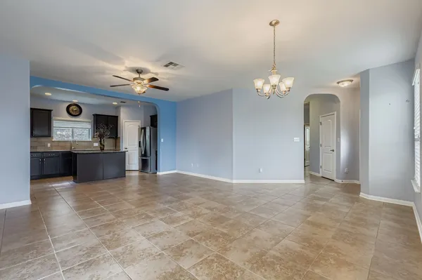 a view of a kitchen with a sink and a chandelier