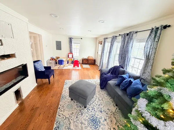 a living room with furniture rug and a window