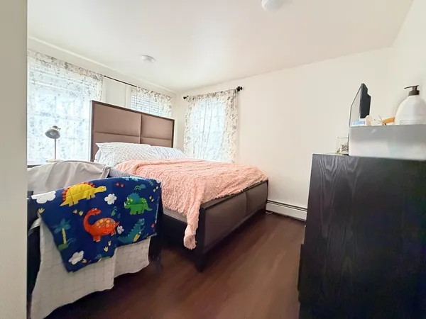 a bedroom with a bed and a dresser