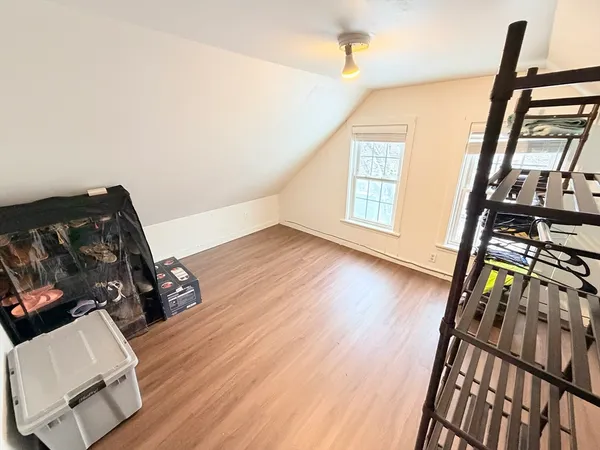 a view of a hallway with wooden floor and stairs