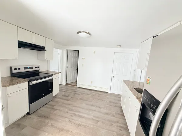 a kitchen with a stove and a refrigerator