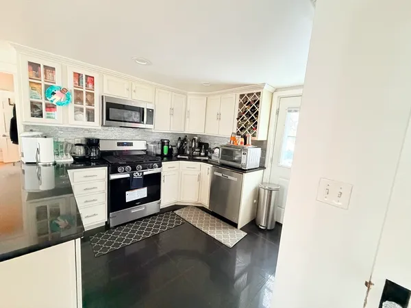 a kitchen with cabinets a sink and a stove