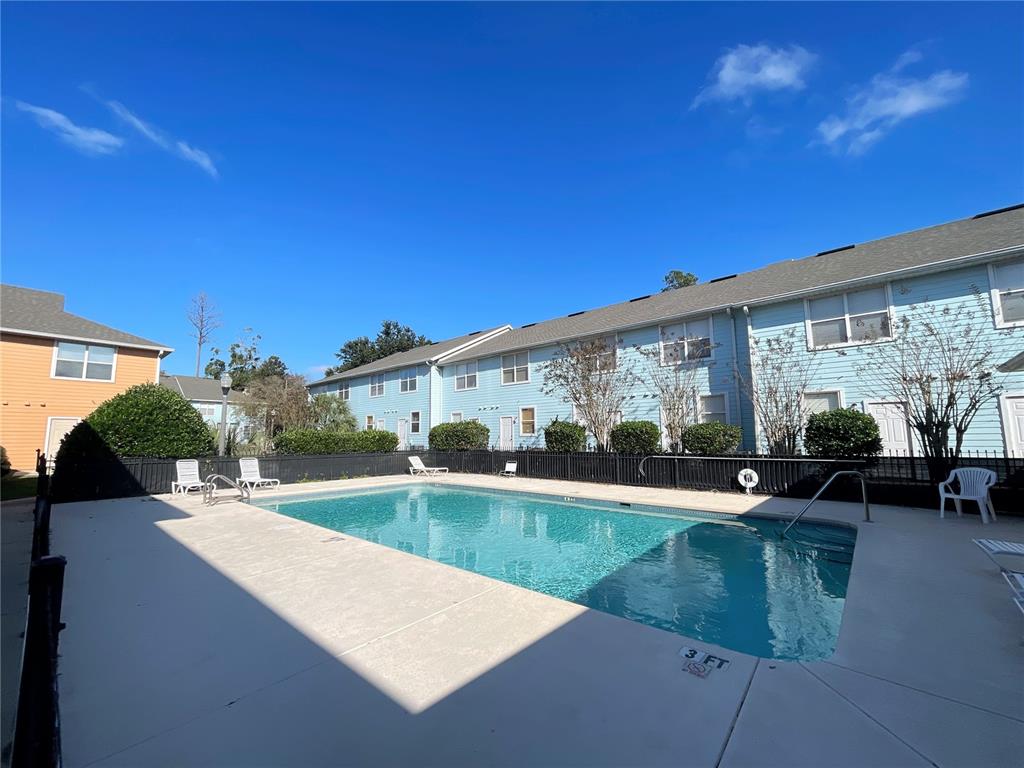 3930 Southwest 20th Avenue, Unit 1902 Gainesville, FL 32607 - Photo 14 of 15 a view of a house with swimming pool and sitting area