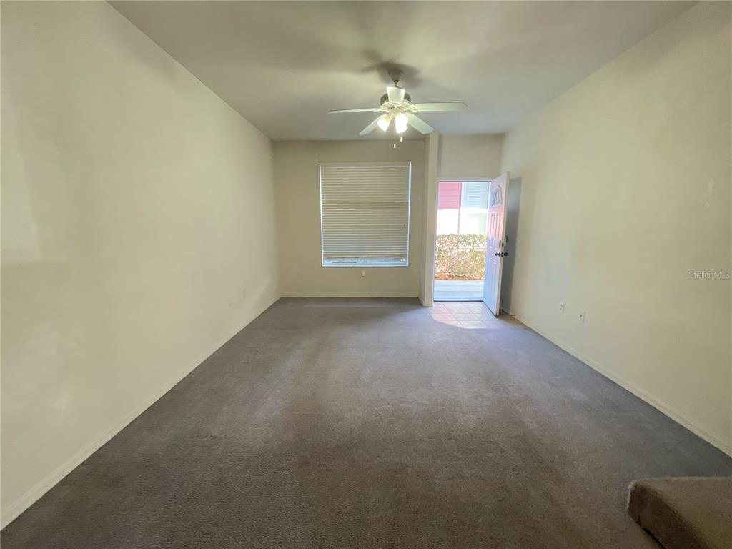 3930 Southwest 20th Avenue, Unit 1902 Gainesville, FL 32607 - Photo 2 of 15 a view of an empty room with a chandelier fan